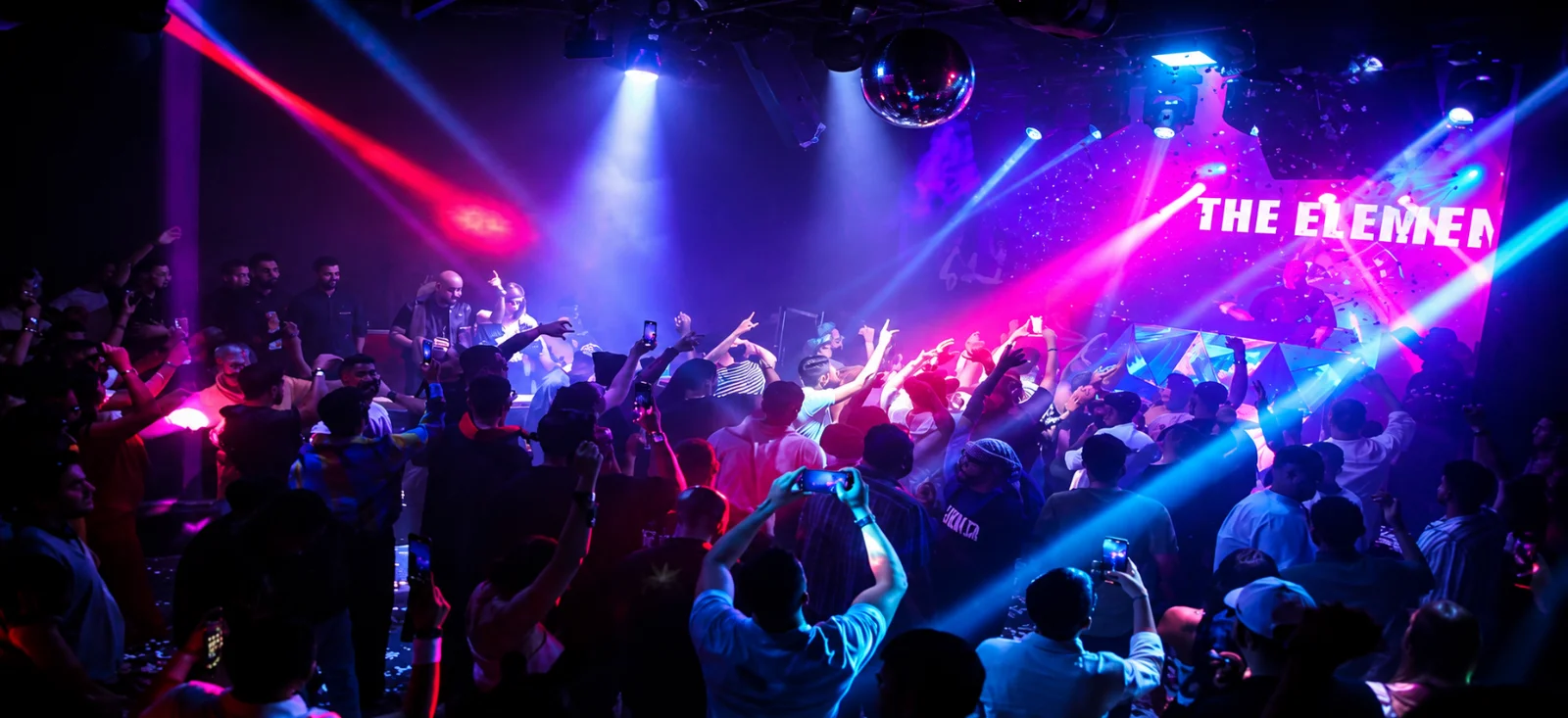 Crowd under stage lights at Klub360